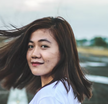 Woman smiling outdoors in daylight